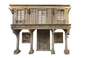 An Indian Haveli Architectural Facade with Three Windows, a Balcony And Set of Pillars